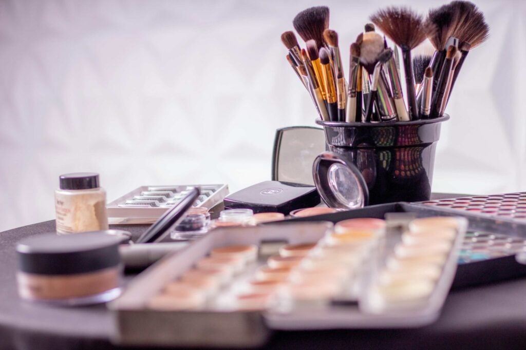 A vareity of cosmetics and make-up brushes