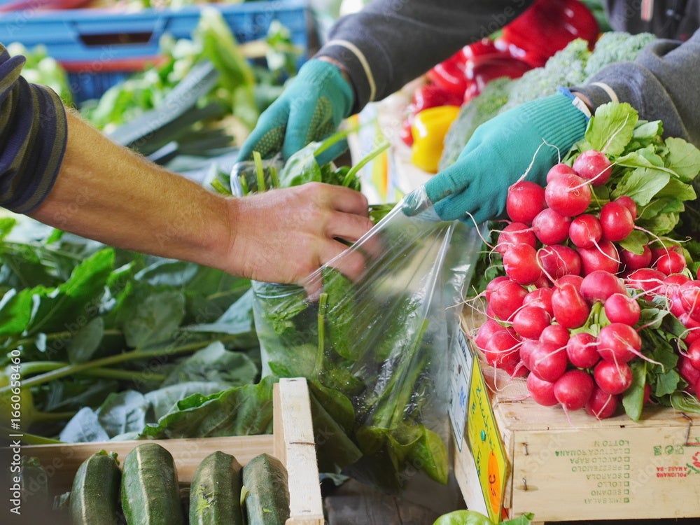 Arm bagging spinach at a farmer's market