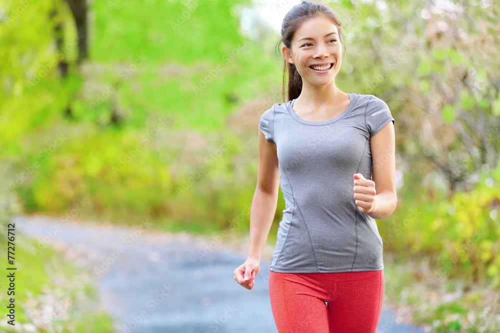 Woman walking for exercise along a path.