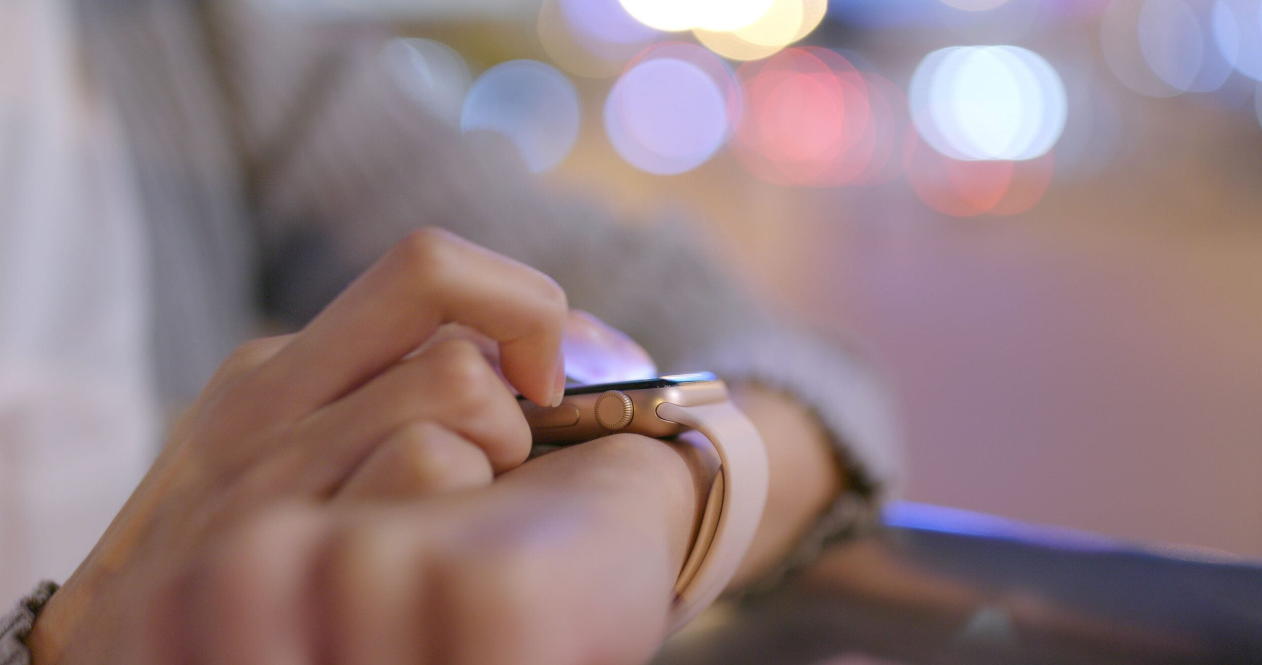 Person touching smart watch on their wrist