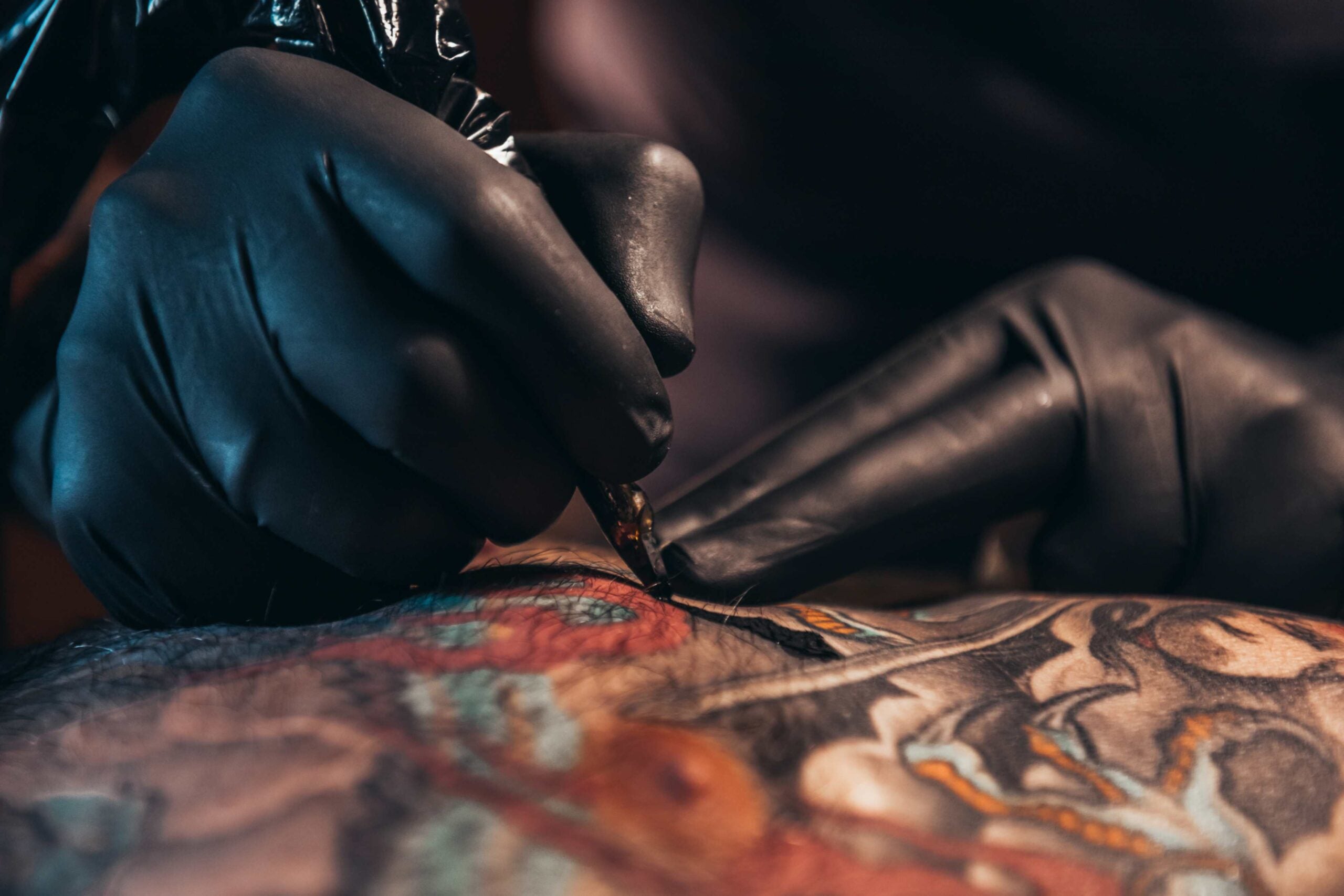 Tattoo artist working on a tattoo