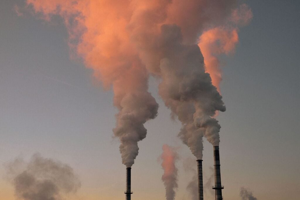 Smoke stacks with smoke coming out of them