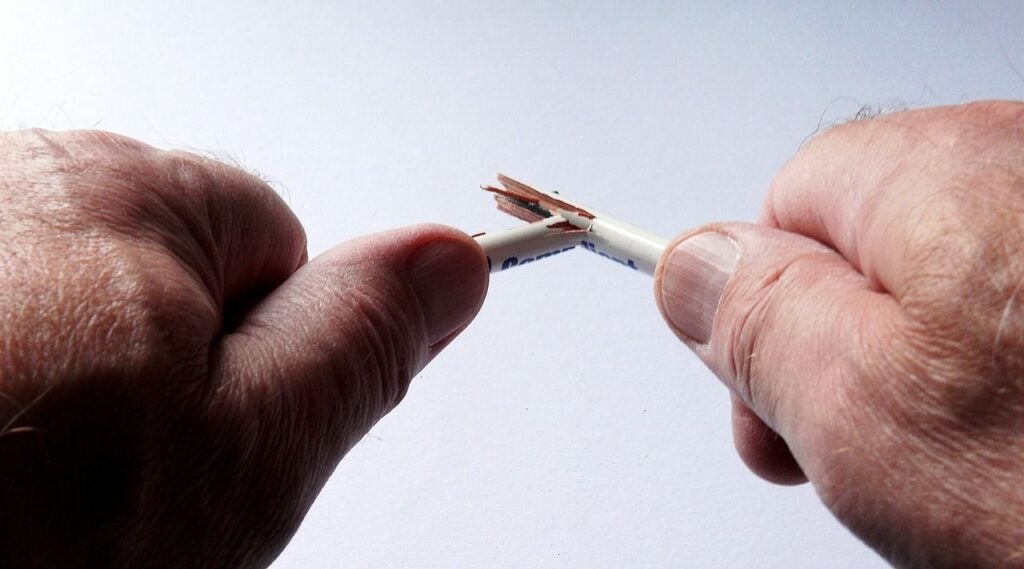 hands breaking a pencil