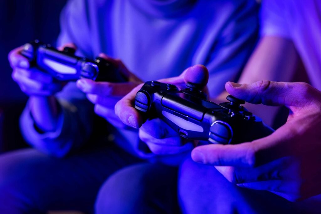 Photo of hands holding video game controllers